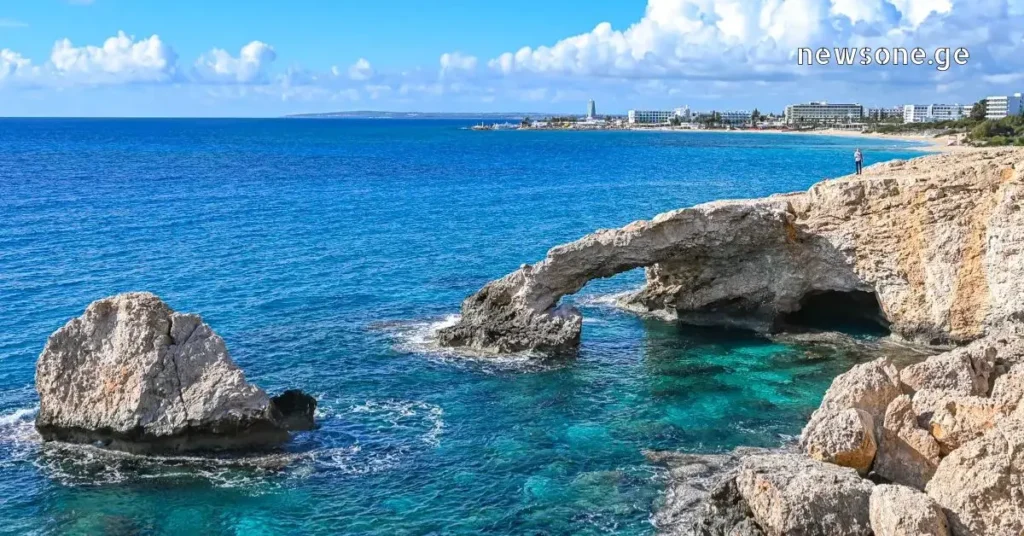 Natural stone bridge and sea caves at Cape Greco near Ayia Napa, Cyprus, with turquoise Mediterranean water.